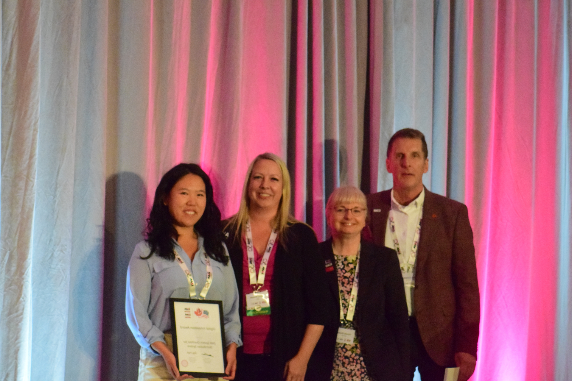 Photo of four members of the asset management team with their IAM award